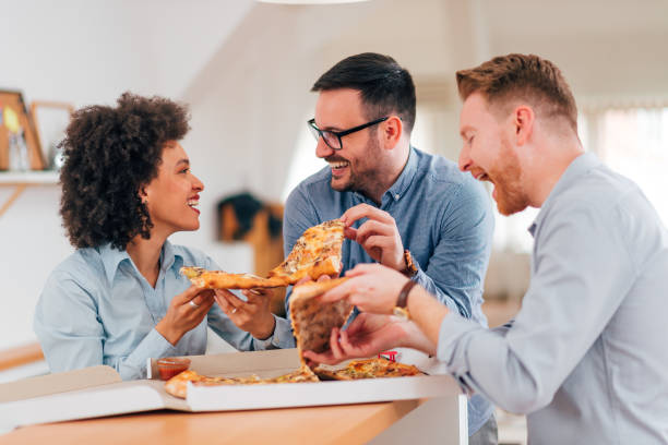 istock Friends eating pizza and having fun, indoors. 1210358908