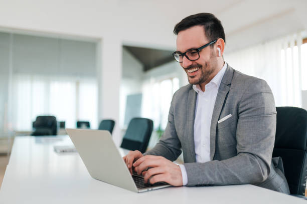 istock Happy businessman using laptop, portrait. 1210358952
