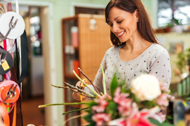 istock Smiling florist making flower bouquet, portrait. 1210358957