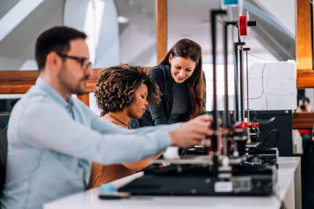 istock Working with 3D printer. Business, innovation, technology and people concept. 1210358973