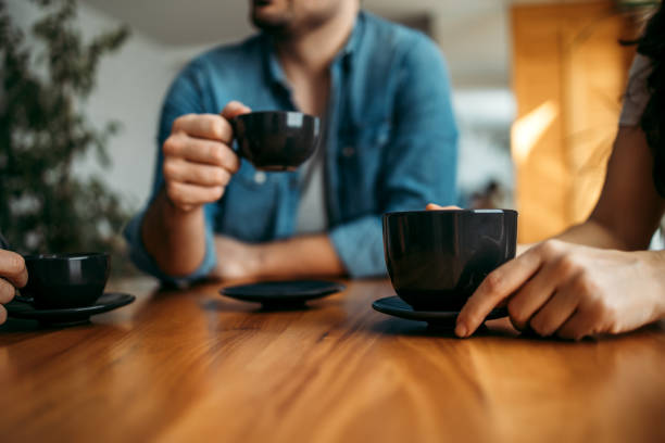 istock Having hot drink with friends, close-up. 1210358990