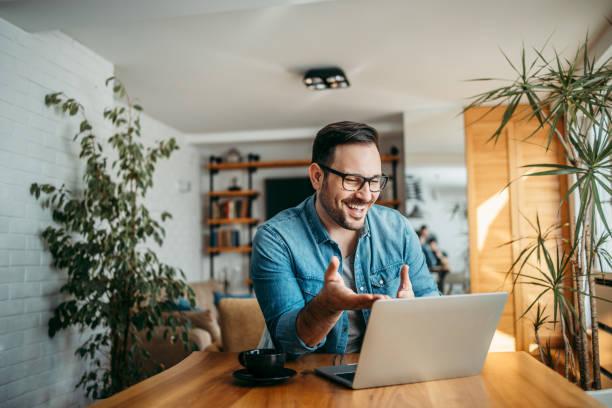 istock Portrait of a cheerful man having video call on laptop computer. 1210358997