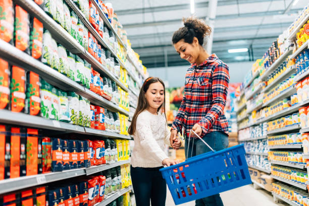 Mother and Daughter Shopping in Supermarket Mother and Daughter Shopping in Supermarket groceries stock pictures, royalty-free photos & images