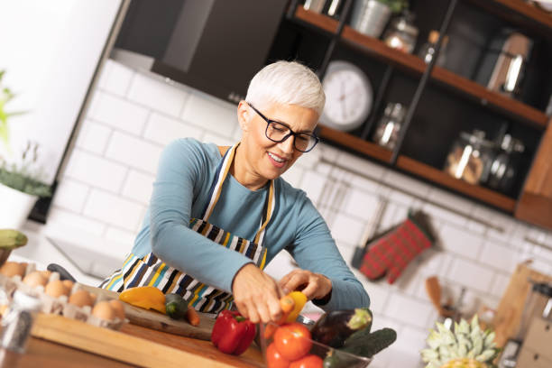 istock Senior woman cooking 1210359911