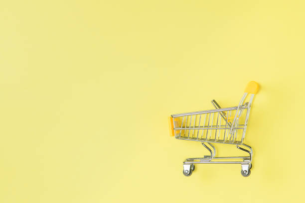istock shopping trolley isolated on yellow background 1210360020