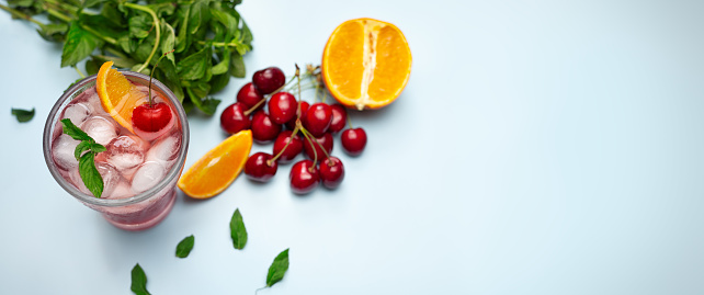 cold and fresh cherries and orange  juice on table with copy space