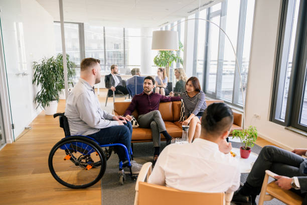 istock Diverse business associates conversing in office lobby 1210364364