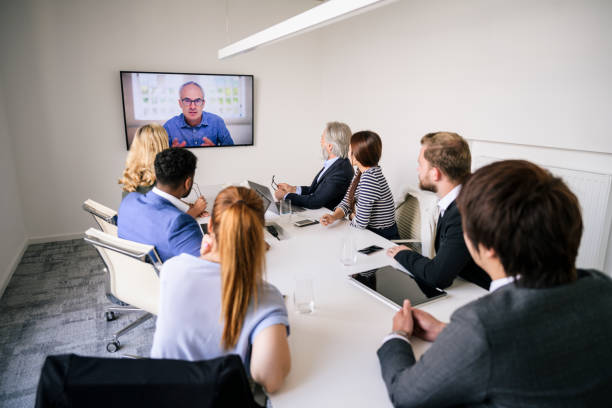 istock CEO video conferencing with executive team in board room 1210364374