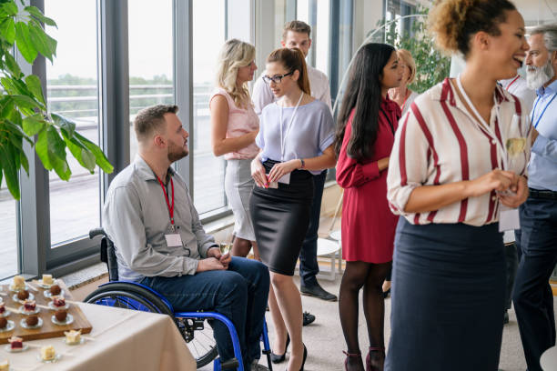 istock Young business people conversing at office social gathering 1210364393