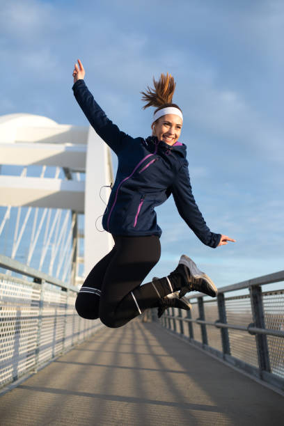 istock Young woman exercising on the bridge 1210366225