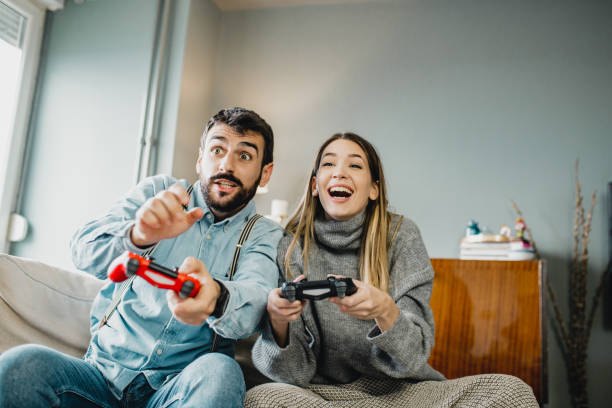 istock Young couple playing video games 1210366707