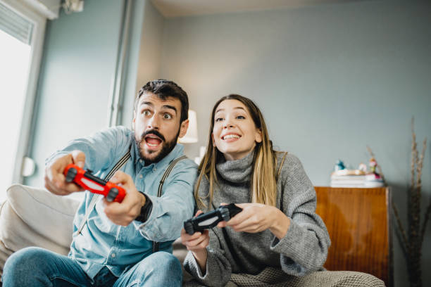 istock Young couple playing video games 1210366715