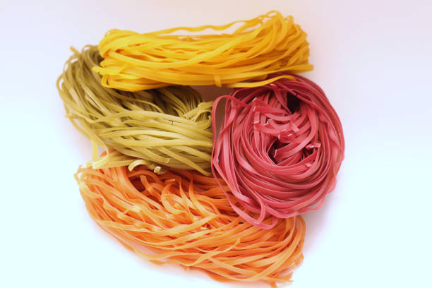 istock Isolated colored spaghetti nests on a white background 1210366815