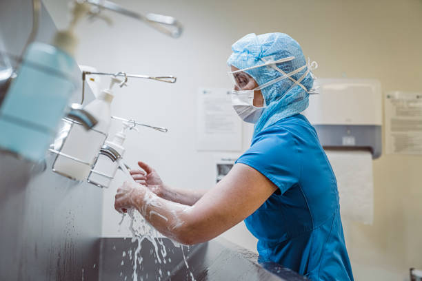 istock Nurse washing hands at medical facility to avoid Covid-19 virus. 1210366833