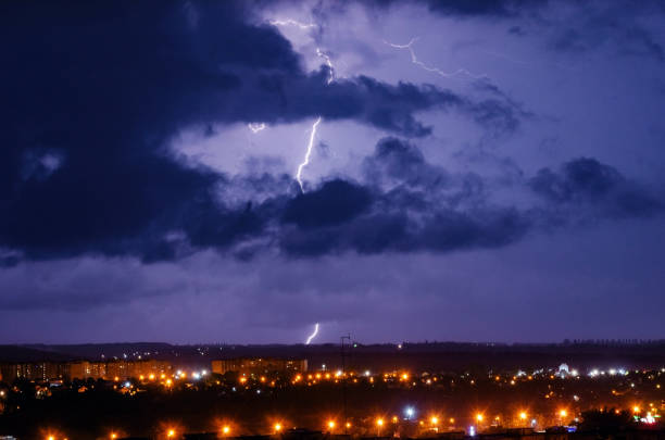 istock Thunderstorm with lightning and thunder over the night city 1210368010