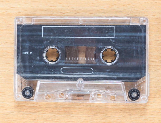 istock Compact Cassette Audio Tape on Wooden Background 1210369282