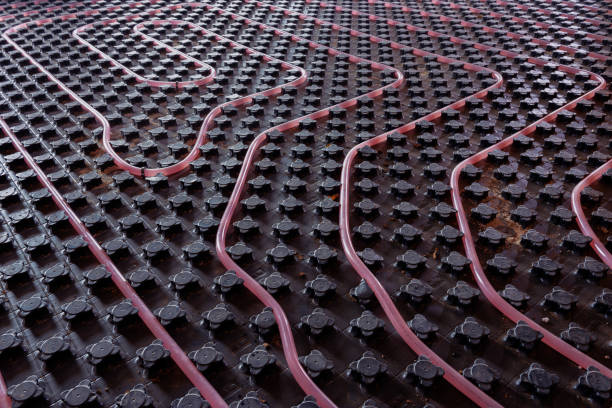 istock Underfloor heating system installation. Close up on water floor heating system interior of a new residential building. Pipes filled with propylene glycol. Individual Heating. 1210370772