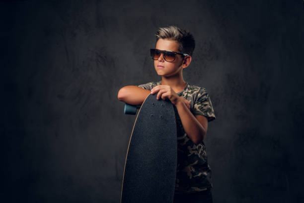 istock Portrait of schoolboy with his skateboard 1210370823