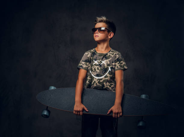 istock Portrait of schoolboy with his skateboard 1210370873