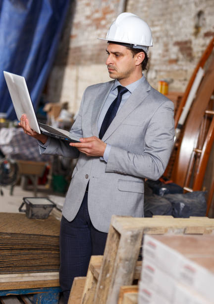 istock Male architect holding laptop 1210370904