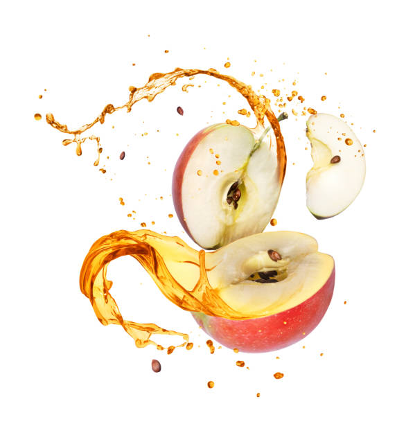 istock Juice splashes out from sliced apple, isolated on white background 1210371261