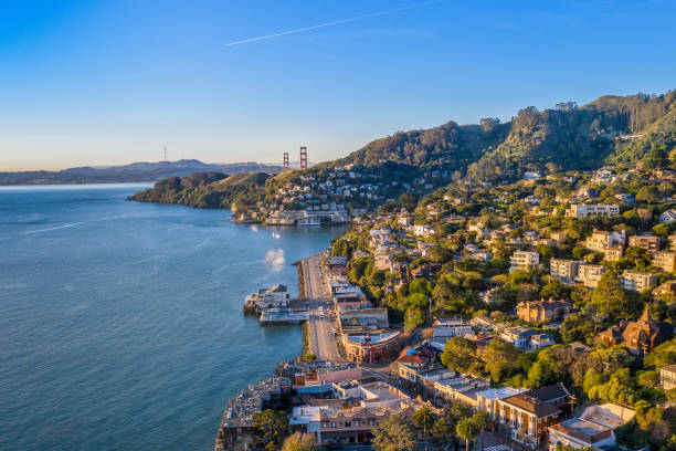 Aerial View of Sausalito with Golden Gate Bridge An aerial view of Sausalito on a golden morning with the Golden Gate Bridge peaking over the hillside. san francisco bay stock pictures, royalty-free photos & images