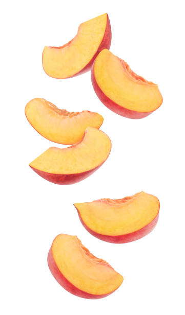 Flying cut peaches Isolated cut peaches. Six pieces of fresh peach fruits in the air isolated on white background peach photos stock pictures, royalty-free photos & images