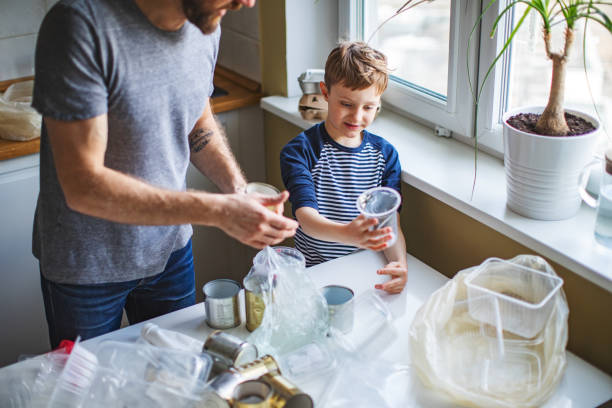 istock Father and son sorting waste at home 1210374962