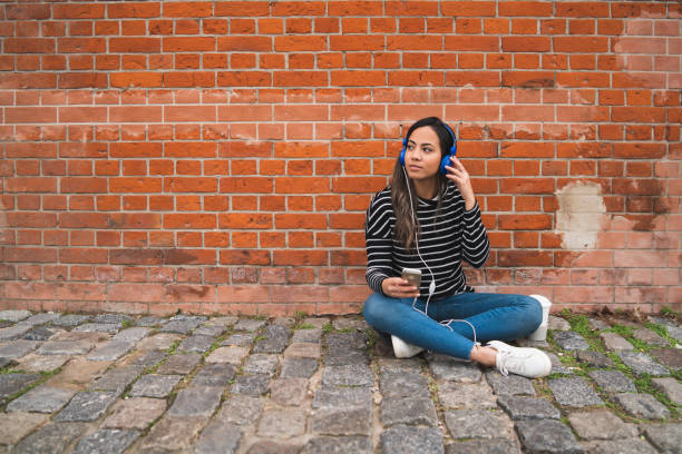istock Woman listening music and using smartphone. 1210375234