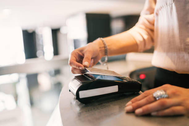 istock Guest makes card payment at check-in at reception. 1210375835
