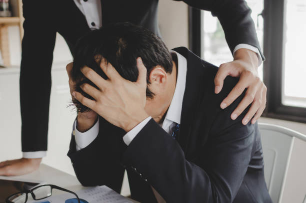 istock sadness asian business man upset about life problems with support from his best friend and sitting in home office, encouragement, fired from job, business problem, financial and investment concept 1210375919