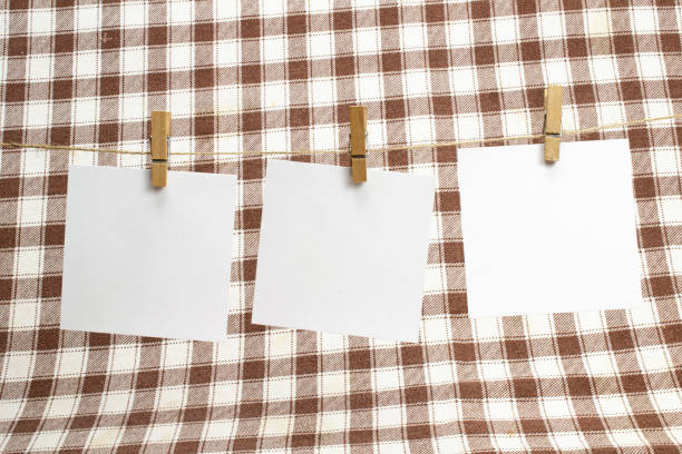 empty paper sheets for notes, frames that hang on a rope with clothespins on textile background . blank cards on rope. mockup template. - adhesive note note pad clothespin reminder imagens e fotografias de stock