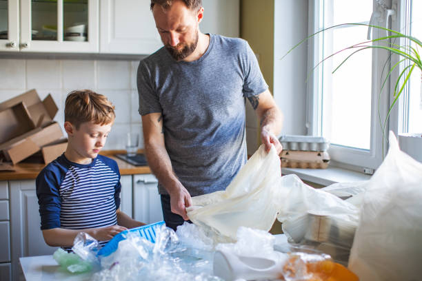 istock Father and son sorting waste at home 1210376035