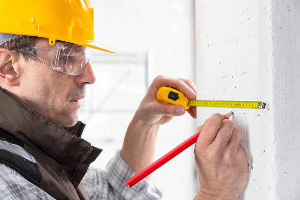 istock Builder marking off a measurement with a pencil 1210376165