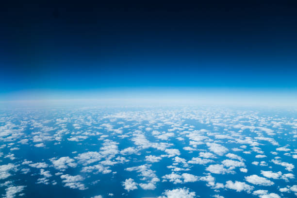 clouds in the stratosphere seen from a plane, with earth's halo in background - earth stratosphere space planet imagens e fotografias de stock