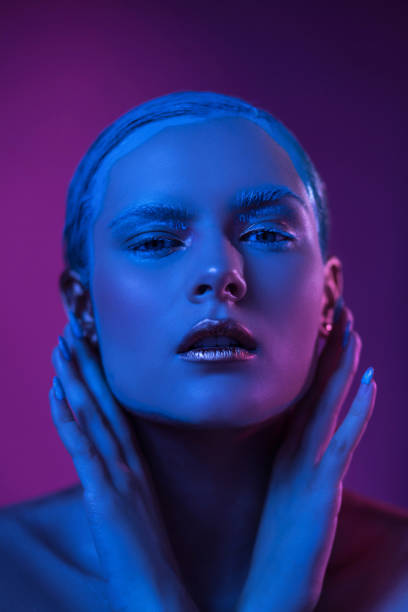 istock Sexy Woman with Creative Make Up Poses in Blue Lights 1210376514