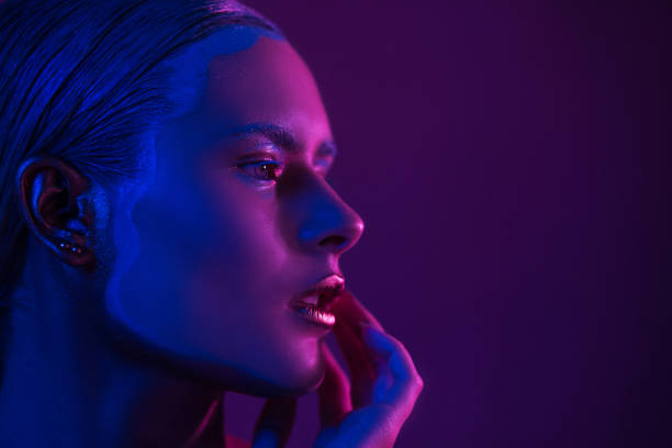istock Sexy Model in Photo Studio on Purple with Blue Neon Lights 1210376546
