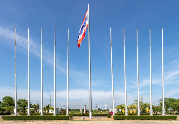 Thai flag on the poles with blue sky cloud and tree on the back side. Thai flag on the poles with blue sky cloud and tree on the back side. thai flag stock pictures, royalty-free photos & images
