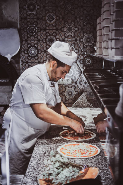 istock Chef is making pizza at the restaurant kitchen 1210378148