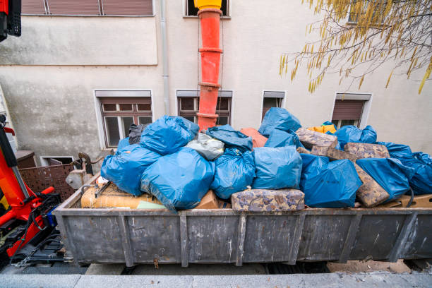 istock The hook lift garbage truck with fool container of garbage 1210378358