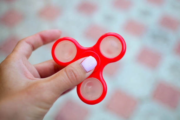 istock The female hand holds spinners 1210380960