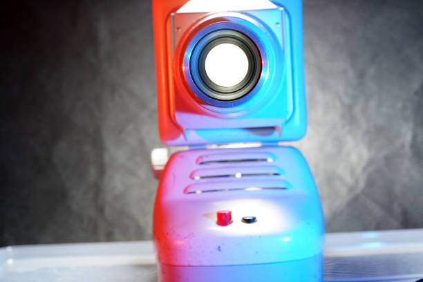 This is an old slide projector with slide frame photographed in the studio with flash light