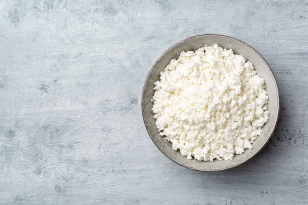 istock Cottage cheese in bowl on concrete background 1210384877