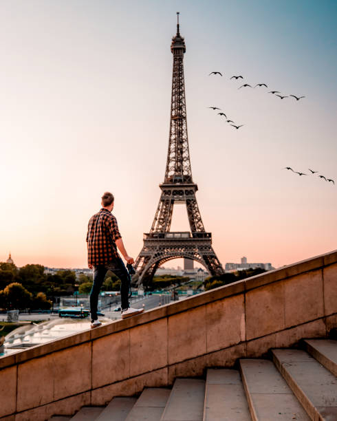 istock young men watching Eiffel tower in Paris. guy tourist visiting Paris France by eiffel tower 1210385549