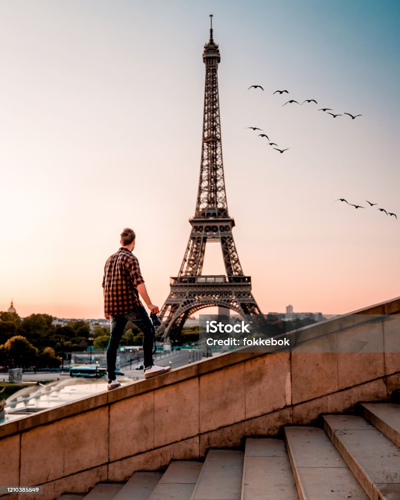 young men watching Eiffel tower in Paris. guy tourist visiting Paris France by eiffel tower young men watching Eiffel tower in Paris. guy tourist visiting Paris France by eiffel tower Europe Adult Stock Photo