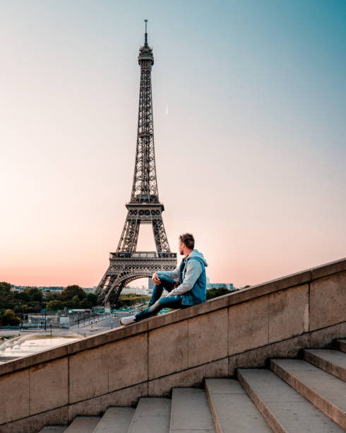 istock young men watching Eiffel tower in Paris. guy tourist visiting Paris France by eiffel tower 1210385721