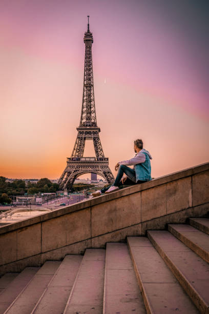 istock young men watching Eiffel tower in Paris. guy tourist visiting Paris France by eiffel tower 1210385787