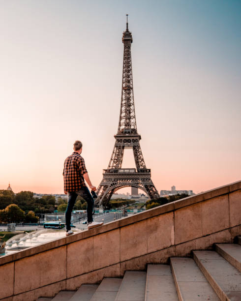 istock young men watching Eiffel tower in Paris. guy tourist visiting Paris France by eiffel tower 1210385896