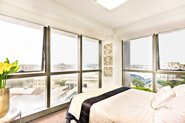 istock Colorful bed with pillows and city view. 1210387490