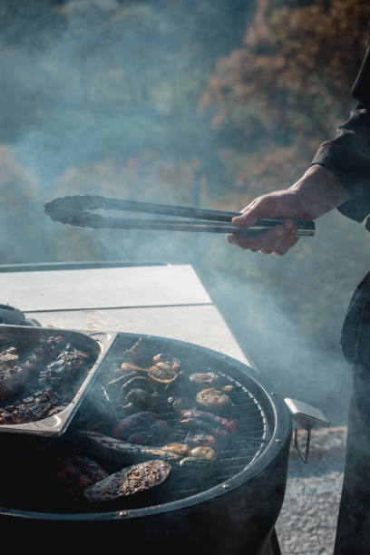 istock meat grilling over the coals on a portable barbecue with vegetables 1210388589
